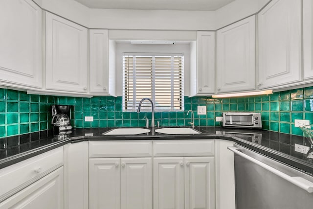 kitchen with white cabinetry, stainless steel dishwasher, sink, and tasteful backsplash