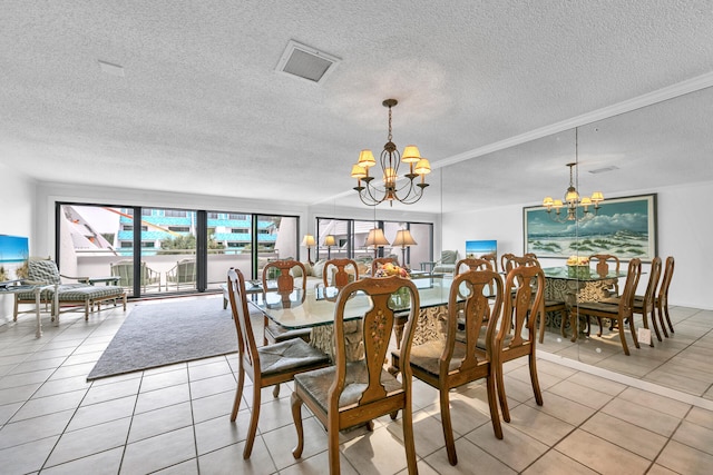 tiled dining space featuring a textured ceiling and a chandelier