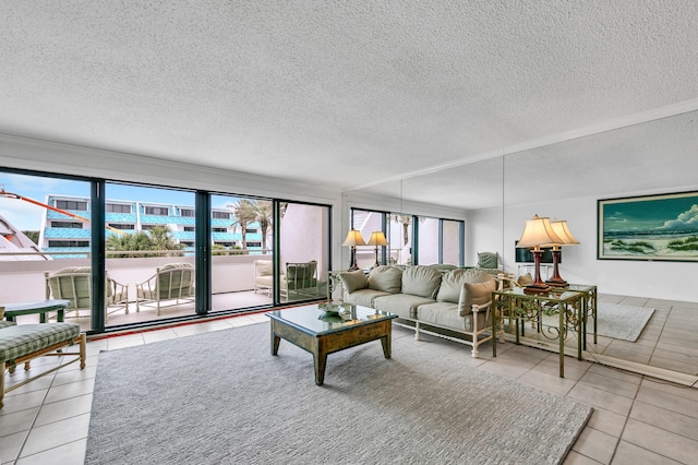 living room with light tile patterned flooring, plenty of natural light, and a textured ceiling