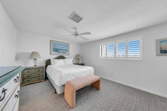 carpeted bedroom featuring a textured ceiling and ceiling fan