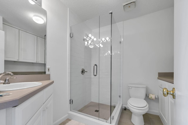 bathroom with vanity, toilet, a textured ceiling, and walk in shower