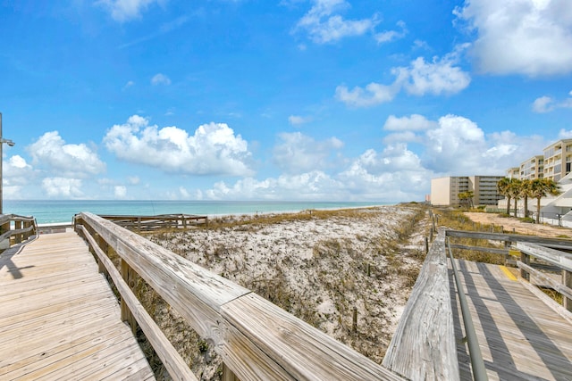 view of community featuring a water view and a beach view