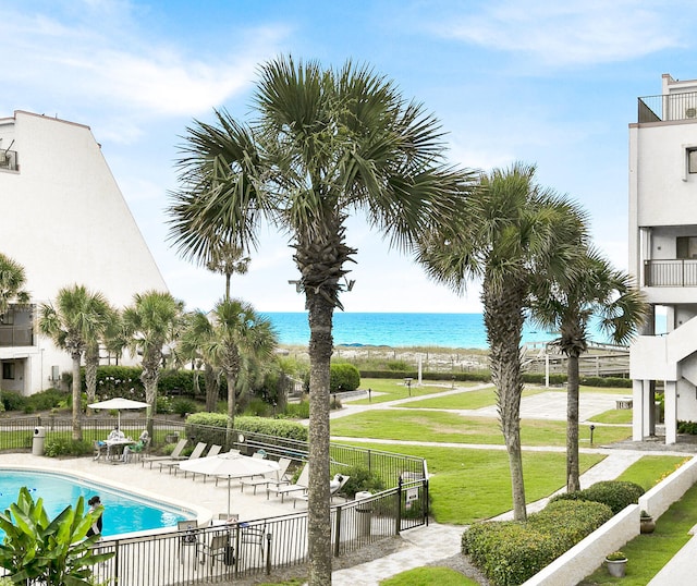 exterior space with a patio, a water view, and a lawn