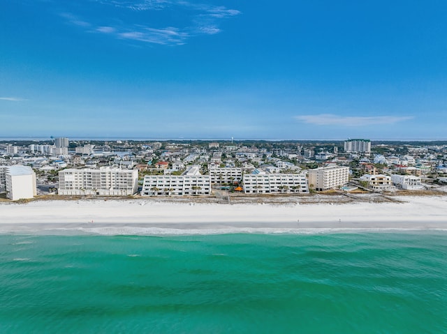 drone / aerial view featuring a water view and a beach view