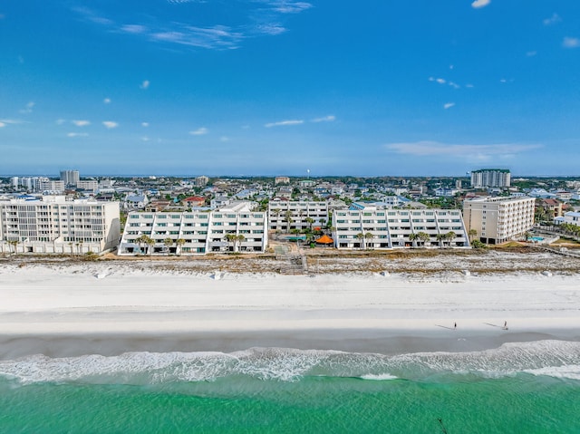 drone / aerial view featuring a water view and a beach view