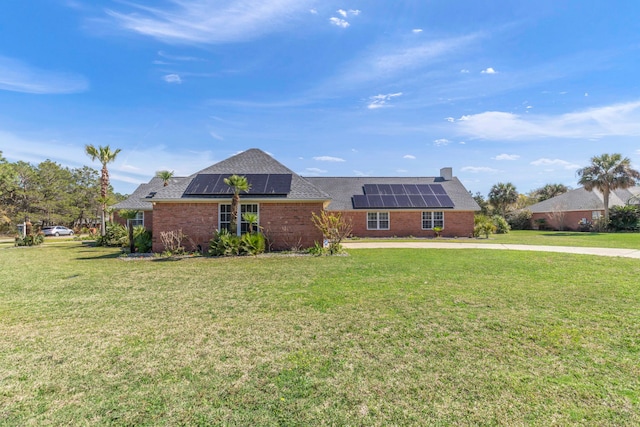 ranch-style house with a front lawn and solar panels