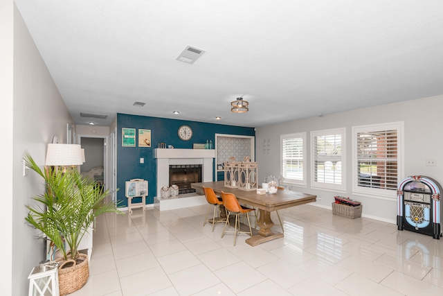 tiled dining space with a tile fireplace