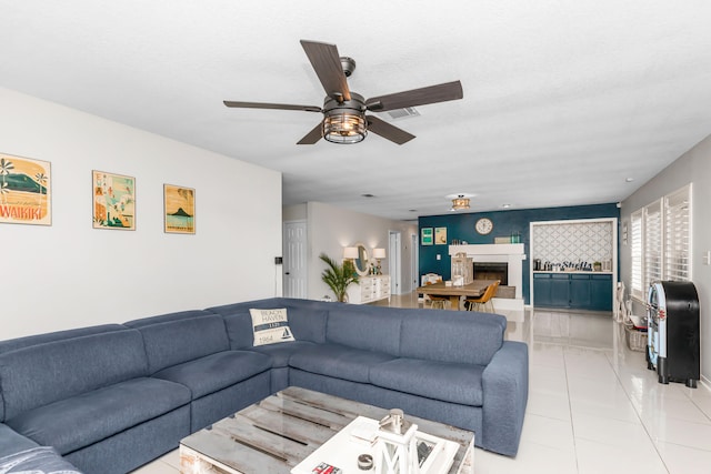 living room with ceiling fan and light tile patterned floors