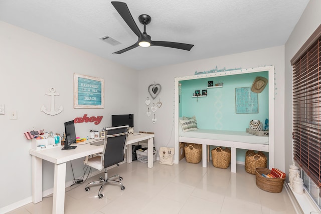 office featuring ceiling fan, light tile patterned floors, and a textured ceiling