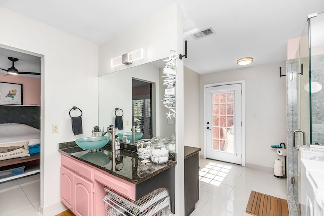 bathroom with a shower with shower door, tile patterned floors, vanity, and ceiling fan