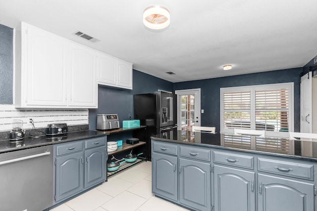 kitchen featuring stainless steel dishwasher, high quality fridge, white cabinetry, gray cabinetry, and light tile patterned floors