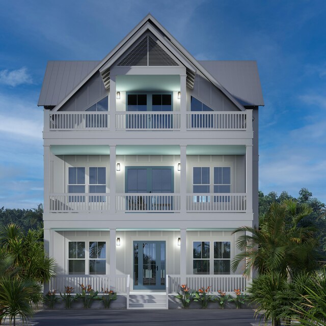 back house at dusk featuring a balcony