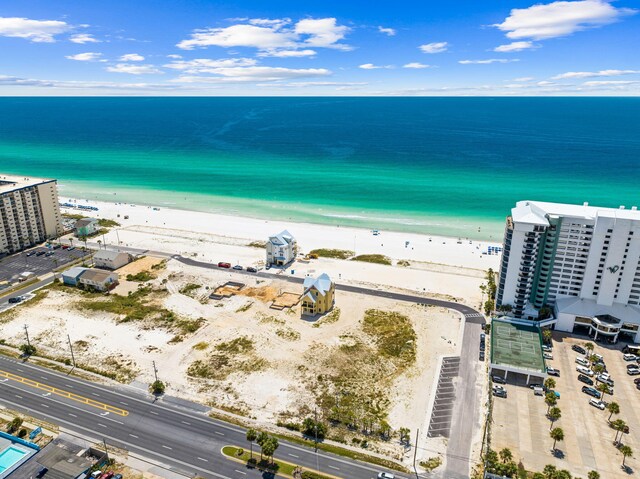 bird's eye view featuring a water view and a beach view