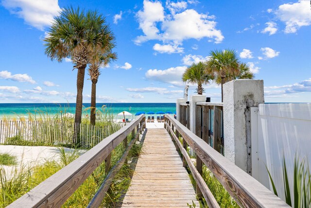 exterior space with a water view and a view of the beach