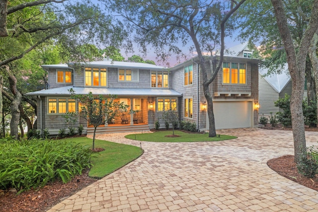 view of front of home with a garage and a lawn