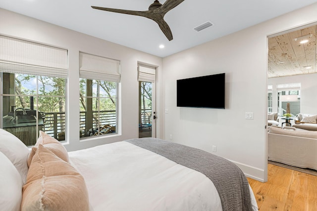 bedroom with ceiling fan, light hardwood / wood-style floors, and access to exterior