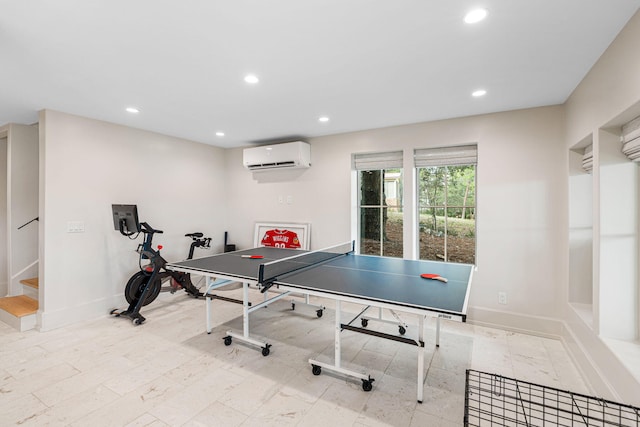 rec room with a wall mounted air conditioner and light tile floors