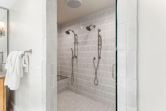 bathroom with a shower with door and vanity