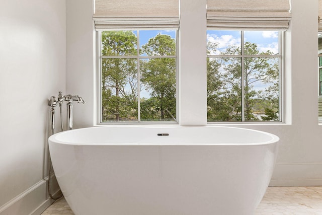 bathroom with a healthy amount of sunlight and tile floors