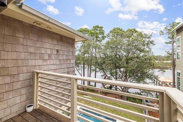 balcony with a water view and a swimming pool