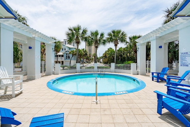 view of swimming pool with a patio area and a pergola