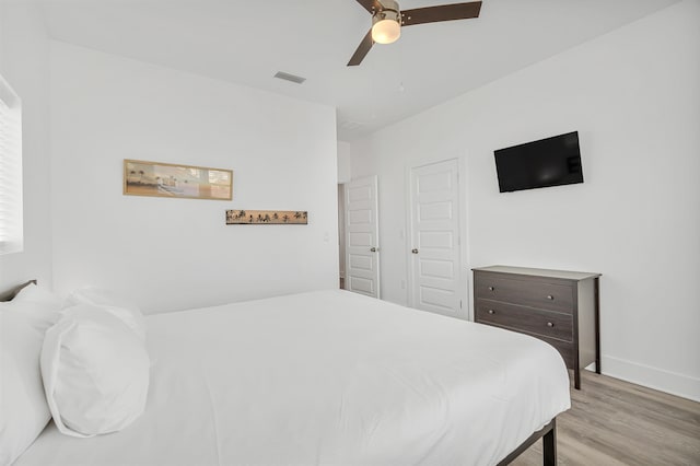 bedroom with light hardwood / wood-style flooring and ceiling fan