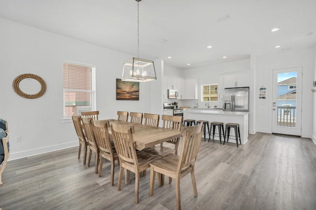 dining area with plenty of natural light and light hardwood / wood-style floors