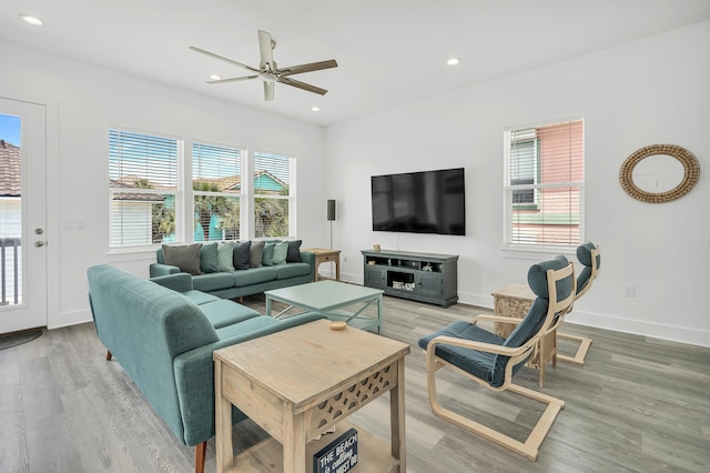 living room with hardwood / wood-style flooring, a healthy amount of sunlight, and ceiling fan