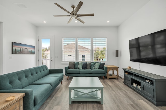 living room with ceiling fan and light wood-type flooring