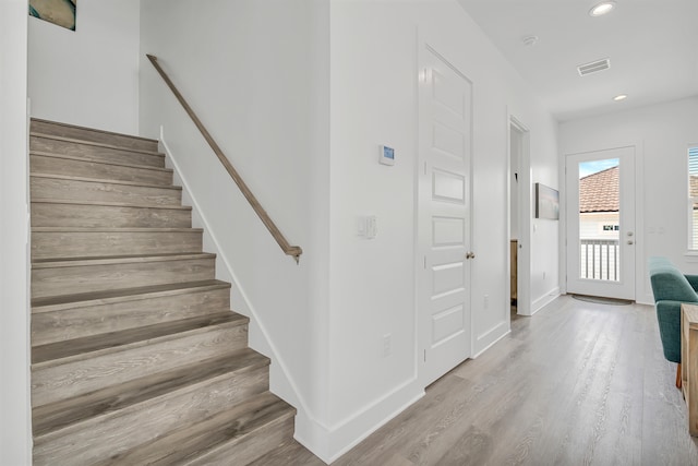 stairway featuring hardwood / wood-style flooring