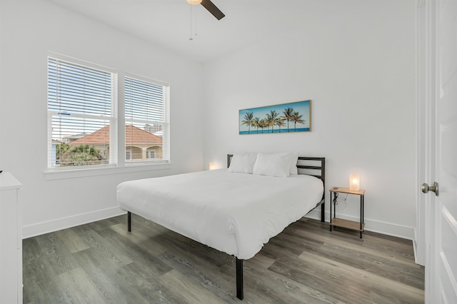 bedroom with dark hardwood / wood-style flooring and ceiling fan