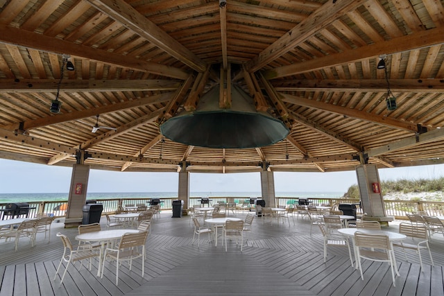 view of dock with a gazebo and a deck with water view