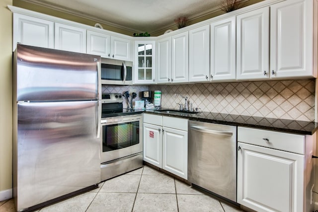 kitchen featuring backsplash, appliances with stainless steel finishes, white cabinets, and sink