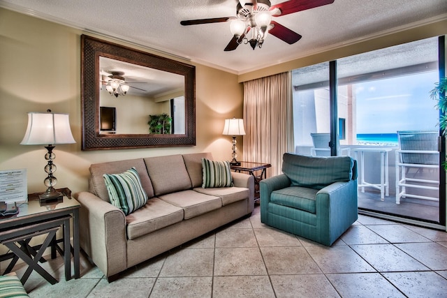 tiled living room featuring a water view, a textured ceiling, ceiling fan, and crown molding