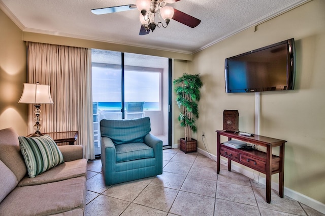 living room with ornamental molding, ceiling fan, a textured ceiling, and a water view