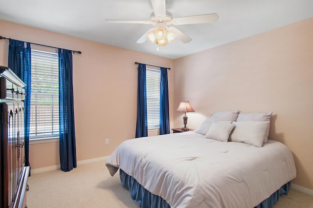 bedroom featuring light colored carpet and ceiling fan