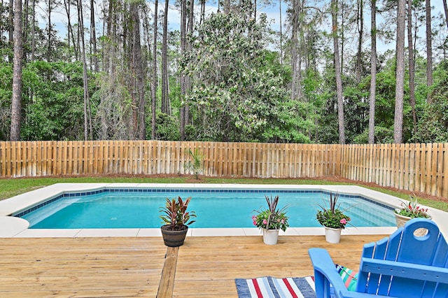 view of swimming pool with a deck