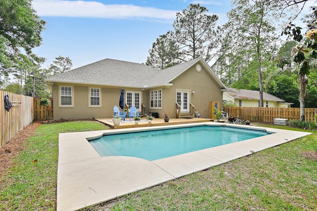 view of swimming pool with a patio area and a lawn