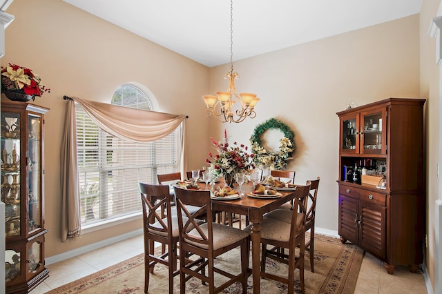 tiled dining area with a notable chandelier and plenty of natural light