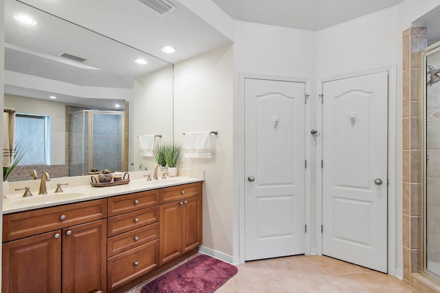 bathroom with vanity, tile patterned floors, and an enclosed shower