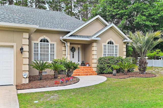 single story home with a front lawn and a garage