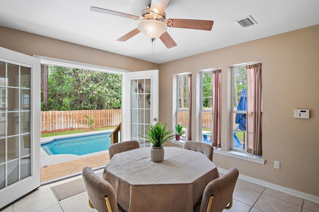 dining space featuring french doors, ceiling fan, and light tile patterned floors