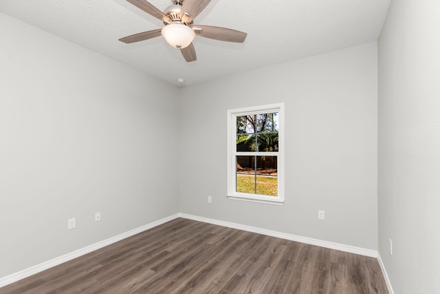 unfurnished room featuring ceiling fan and dark hardwood / wood-style flooring