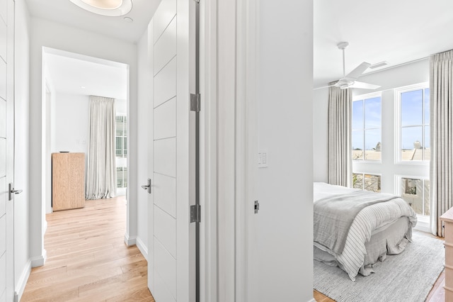 bedroom with ceiling fan and light wood-type flooring