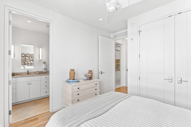 tiled bedroom with a closet, ceiling fan, and sink