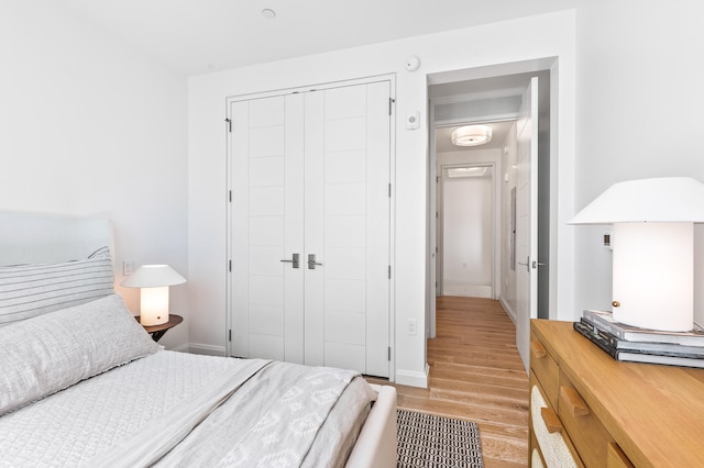 bedroom featuring light hardwood / wood-style flooring and a closet