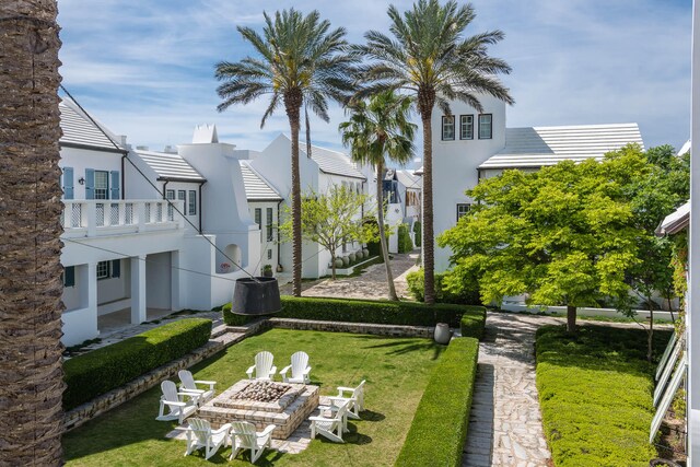 view of yard with a patio, a fire pit, and a balcony