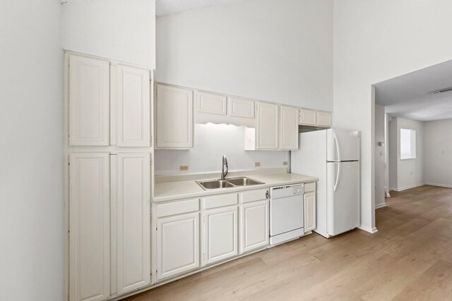 kitchen featuring light hardwood / wood-style flooring, white appliances, sink, and white cabinetry