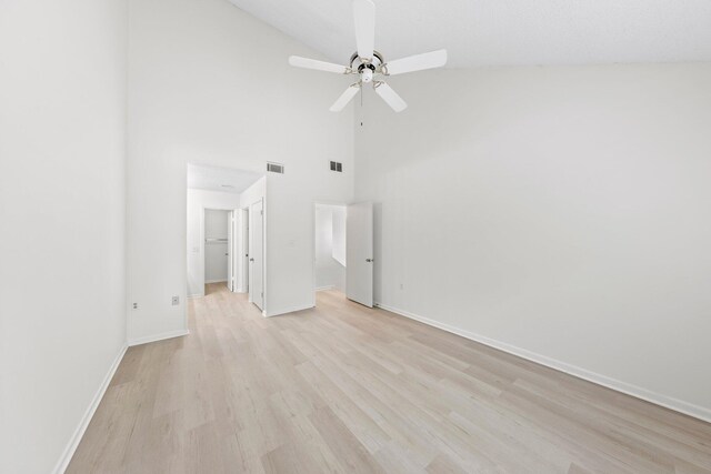 unfurnished bedroom with high vaulted ceiling, ceiling fan, and light wood-type flooring