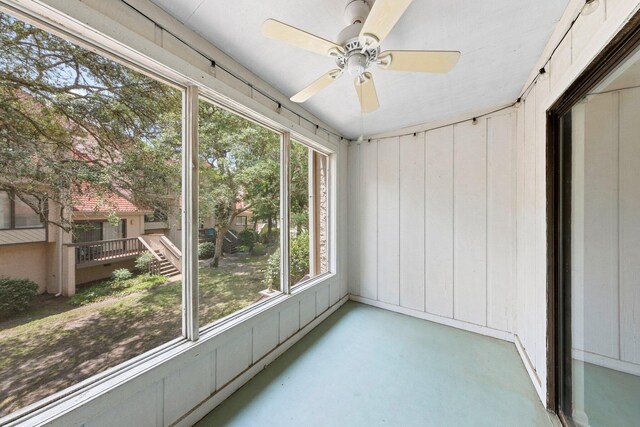 unfurnished sunroom featuring plenty of natural light and ceiling fan